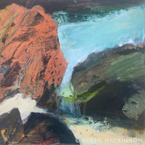 Abstract image of orange and grey white rocks with a blue ocean with waves and sea spray