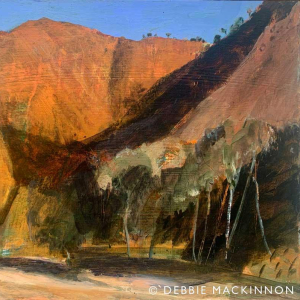 Large orange rocky mountains with trees in the foreground