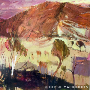 Pink mountains in the distance with green and pink trees over a yellow landscape