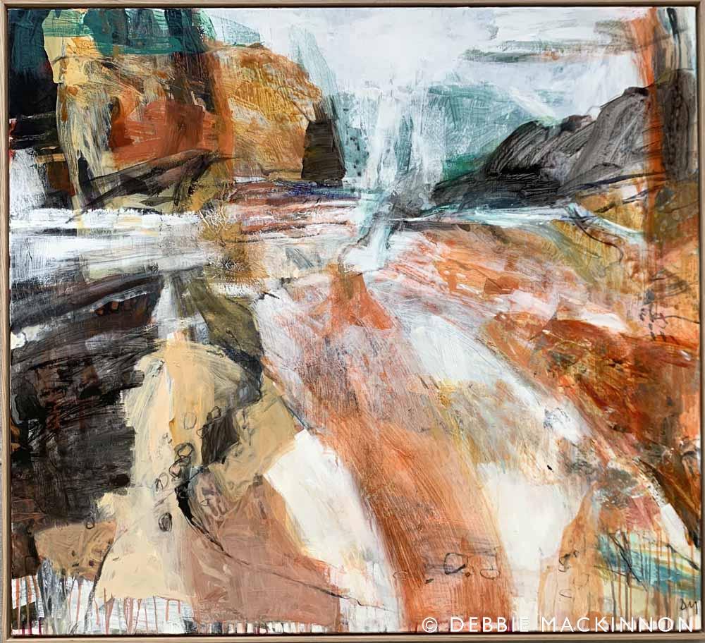 Abstract orange and grey white rocks with a blue ocean with waves and sea spray