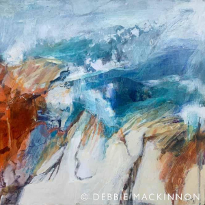 Abstract image of orange and grey white rocks with a blue ocean with waves and sea spray